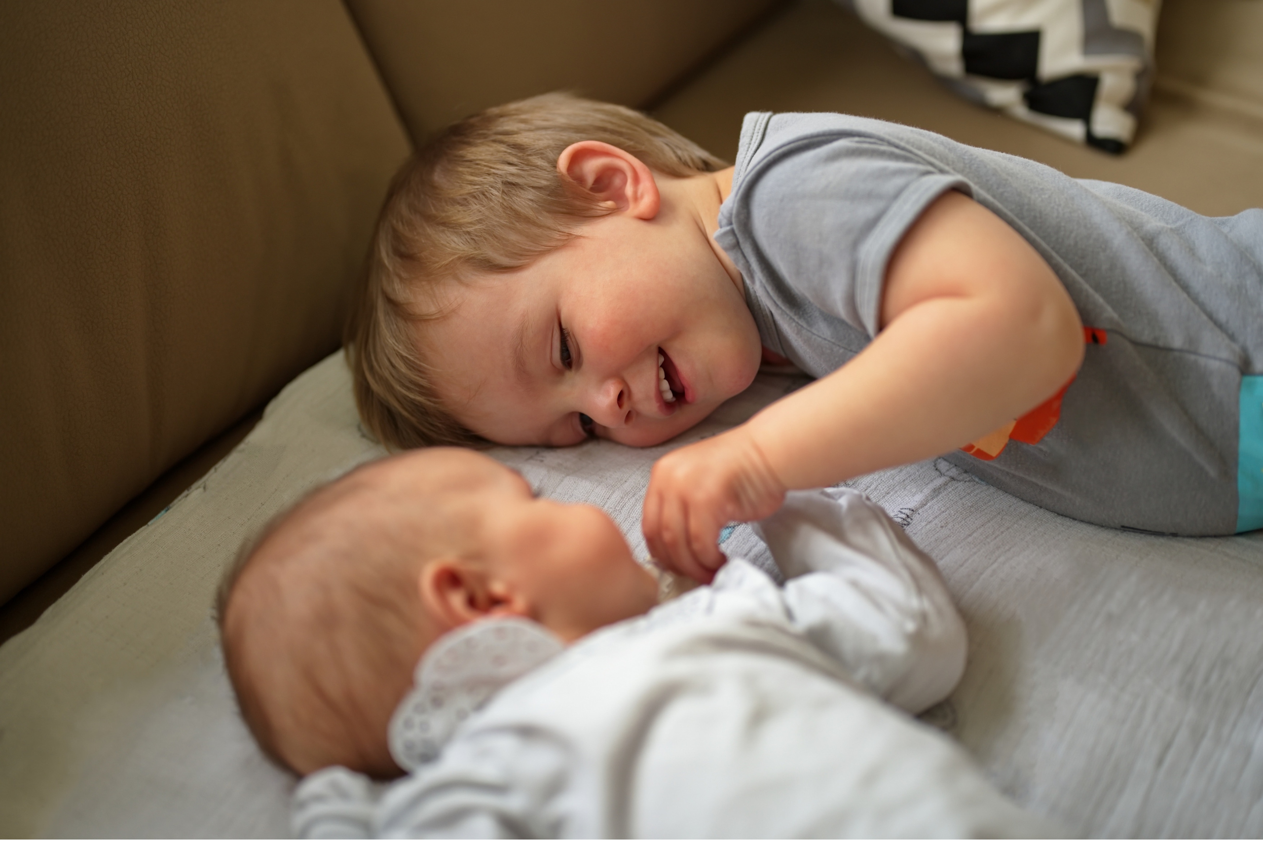 toddler-bonding-with new-sibling-positive-connection-moment
