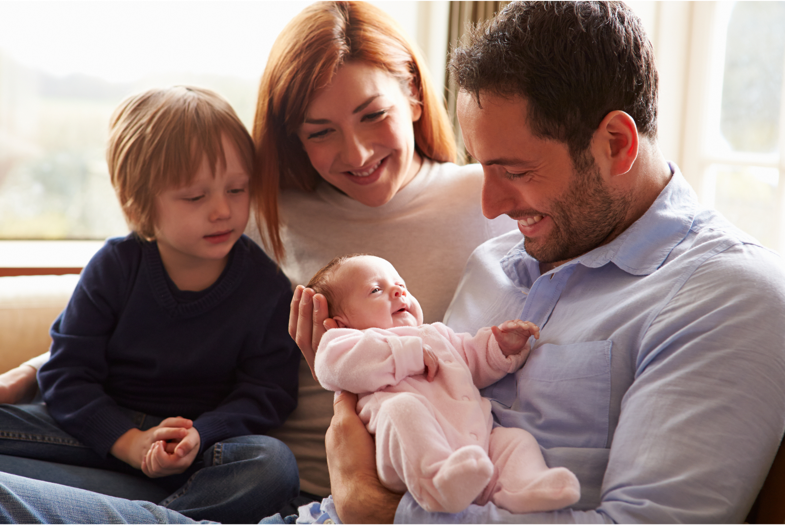 Family-sitting together-on-couch,-calm-and-connected