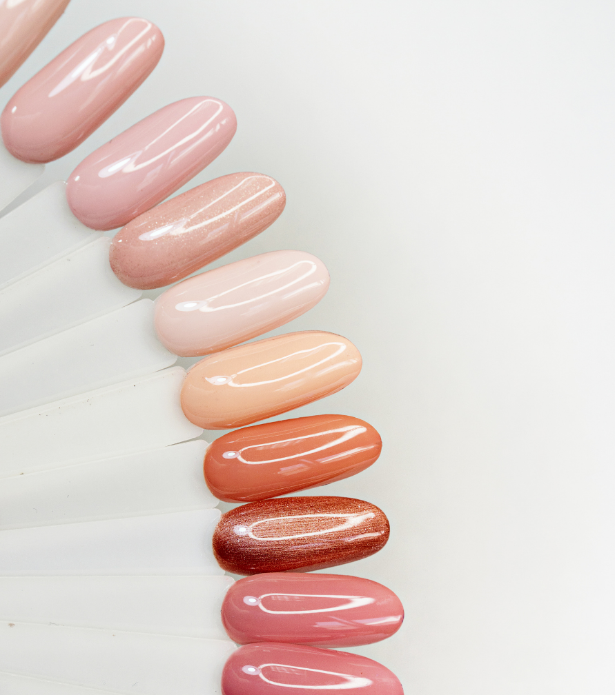 Nude, milky white, soft pink, beige nail swatches on clean background.